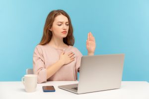 I-swear-Honest-responsible-woman-making-loyalty-promise-oath-and-looking-at-laptop-screen-talking-on-video-call-1221348302_726x484-300x200